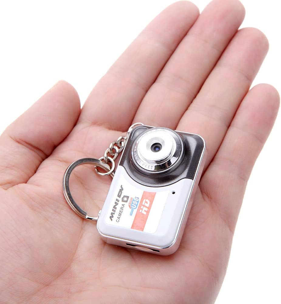 Ultra mini Digital Camera X6 keychain with sleek portable design and 32GB memory in hand.