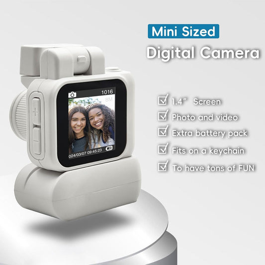 Mini digital camera with 1.4-inch LCD screen, compact design, 1080P video recording, additional battery pack, and keychain attachment.